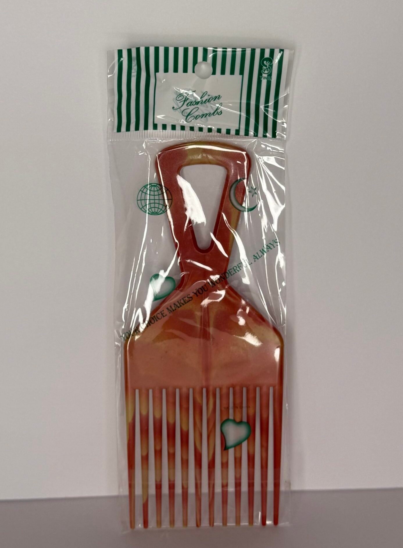 Lightweight afro pick comb with wide, sturdy teeth designed to lift, shape, and add volume to natural textured hair. Perfect for daily styling.